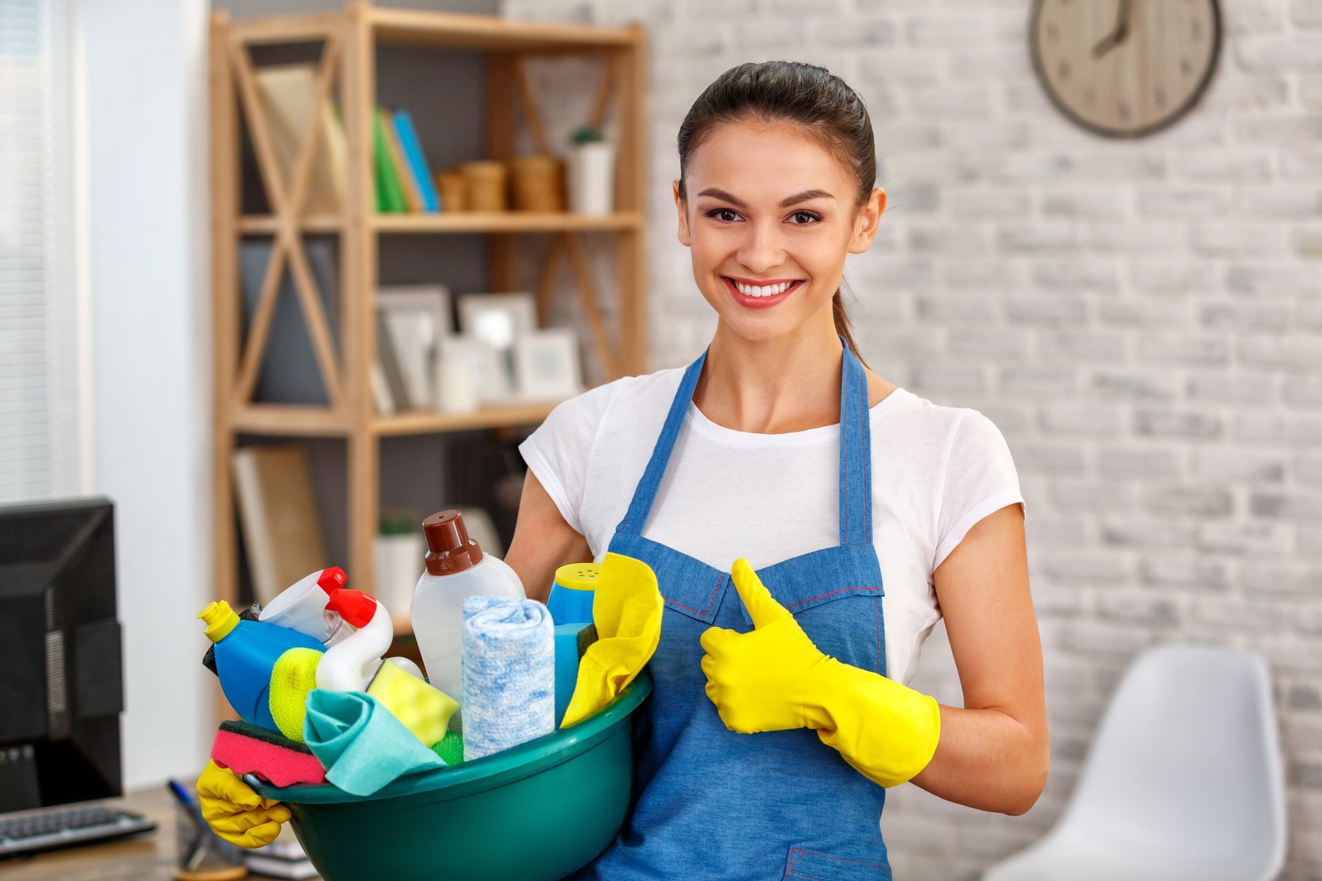 Two buckets of cleaning supplies in a bright room, vacuum cleaner in background.