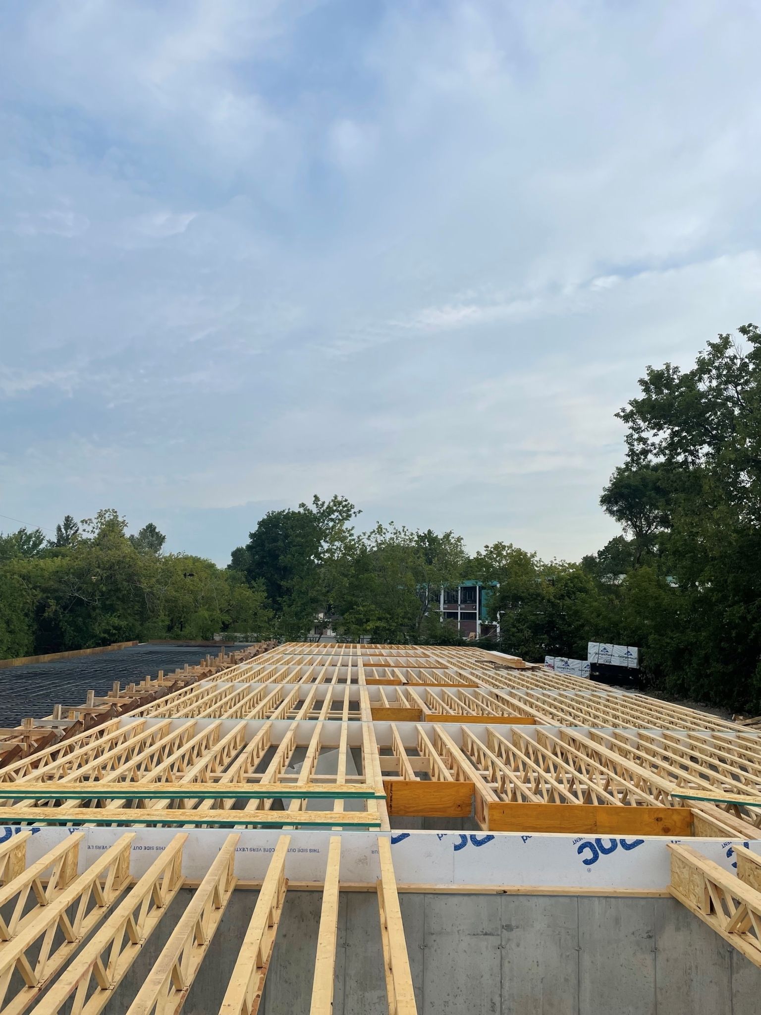 Le toit d'un bâtiment est en cours de construction avec des poutres en bois.