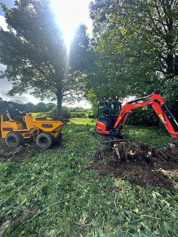 Tractor & Digger in outside space clearing a site