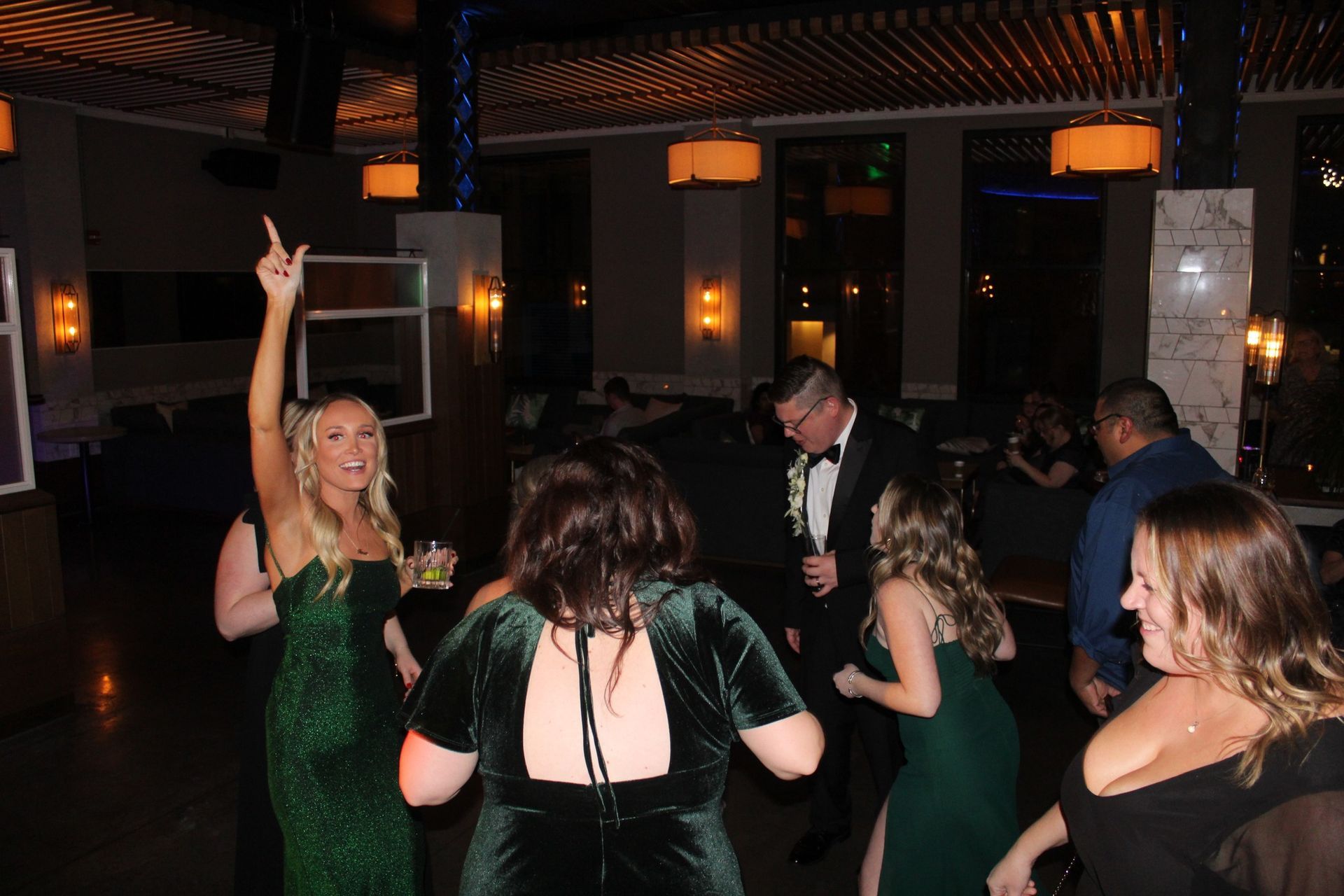 A group of people are dancing in a room at a party.