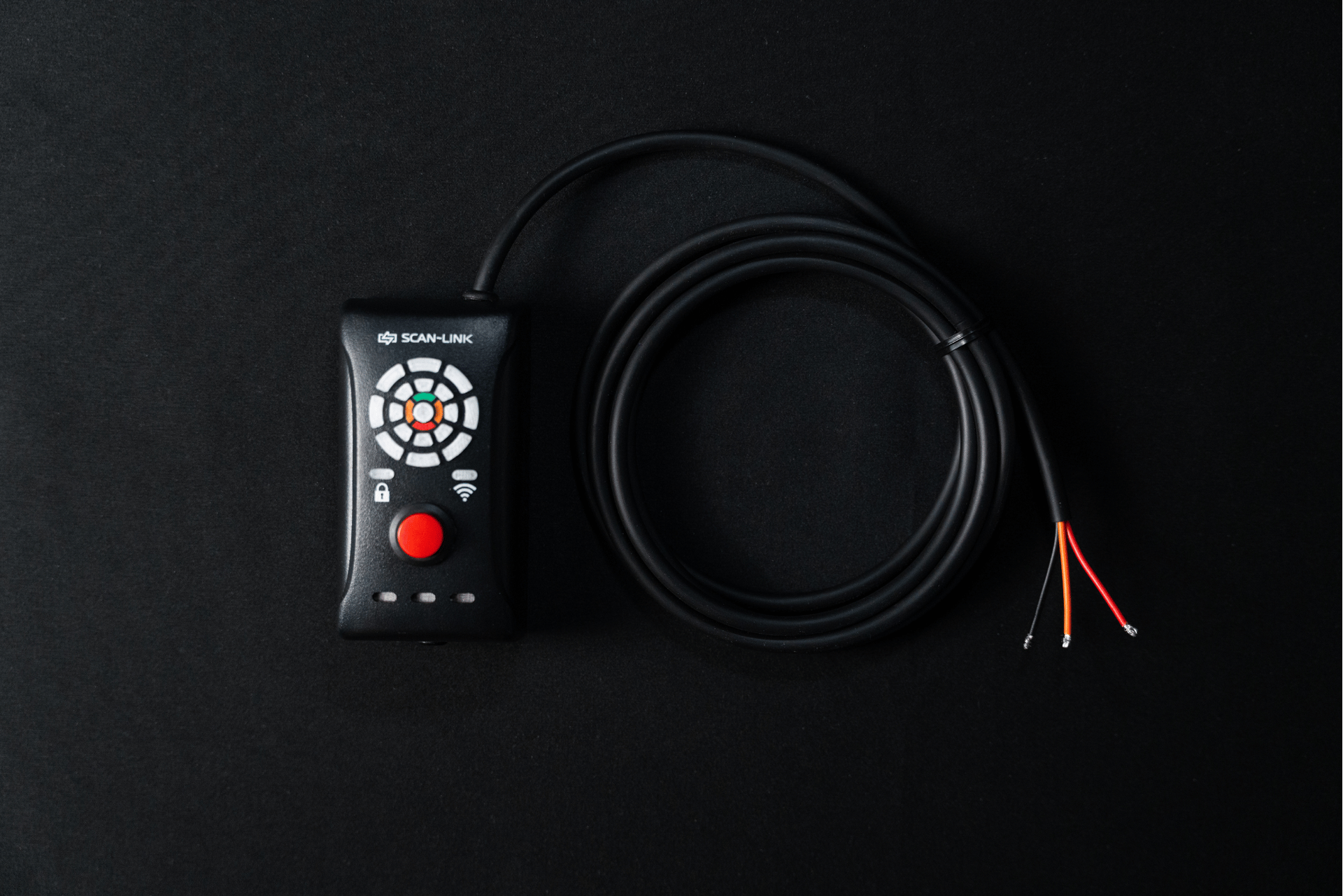 Black Scan-Link device with a red button, circular keypad, and wire on a black background.