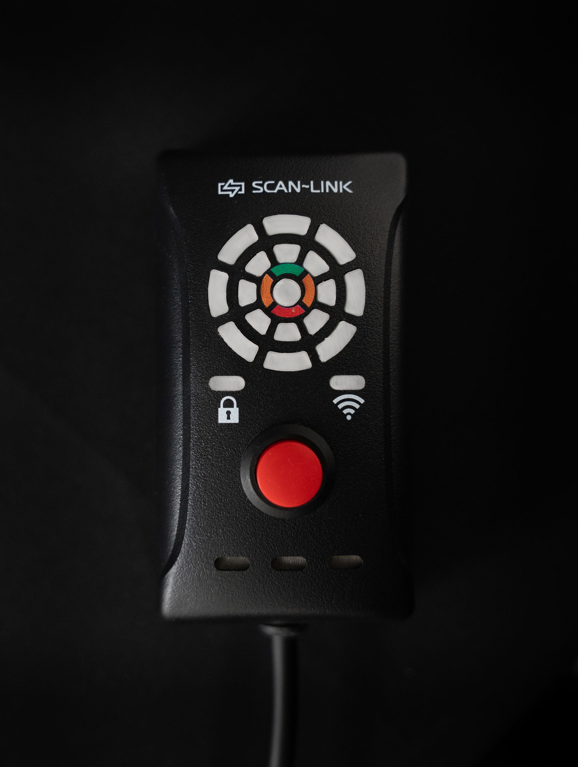 Black Scan-Link device with a red button, circular patterned lights, and Wi-Fi icon on a dark background.