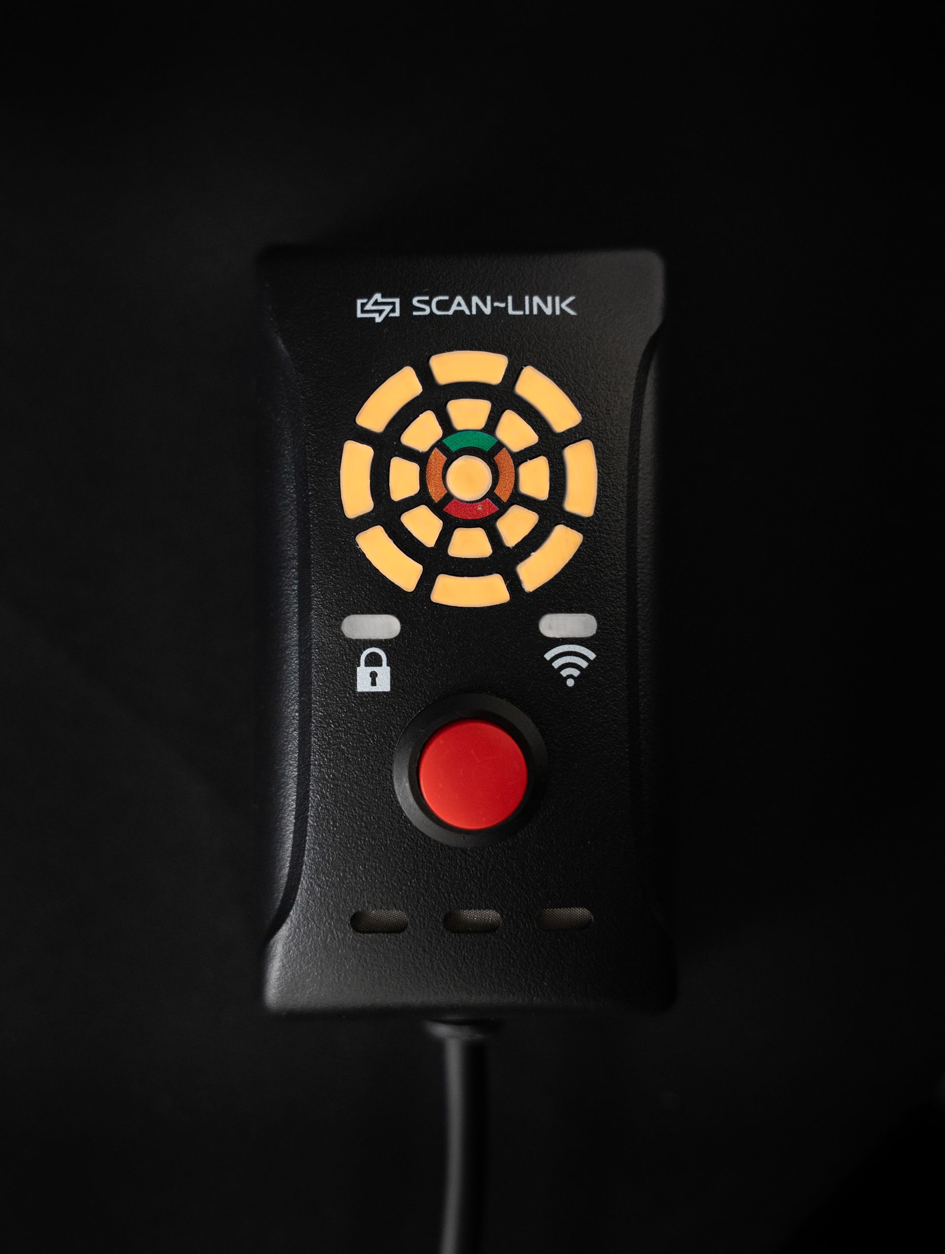 Black Scan-Link device with a red button, and multi-colored circular display, against a black backdrop.