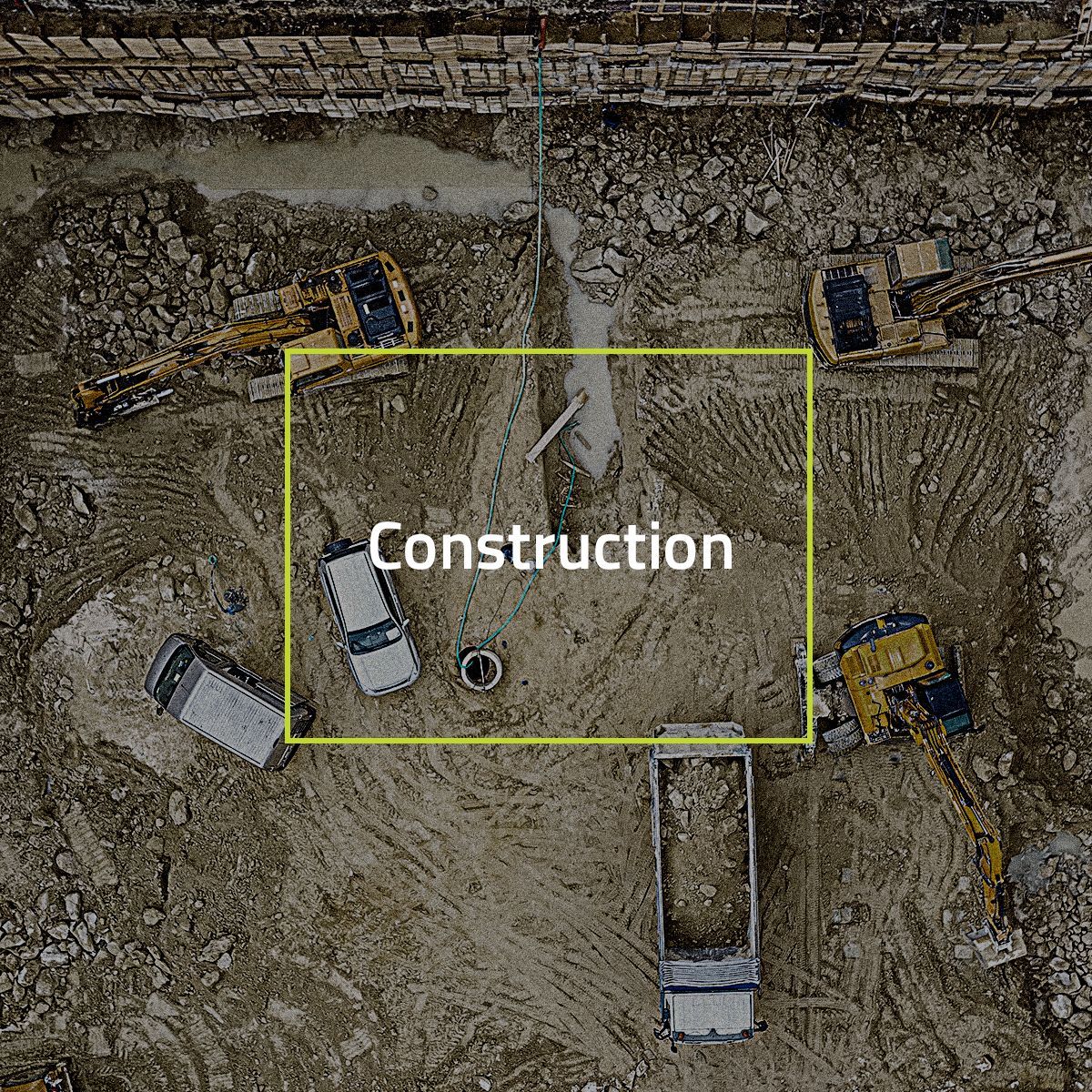 An aerial view of a construction site with trucks and tractors.