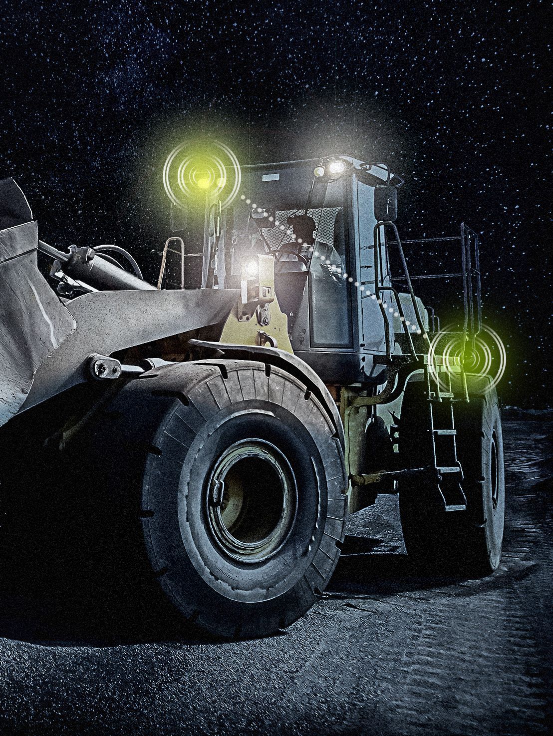 A bulldozer is parked on a dirt road at night with its lights on.