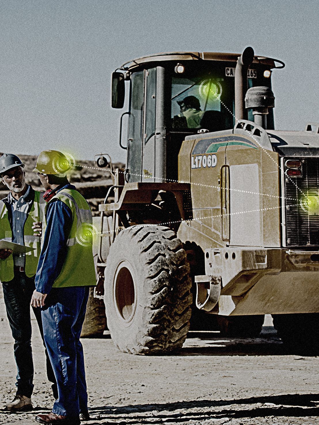 Two construction workers are standing in front of a bulldozer that says litroad