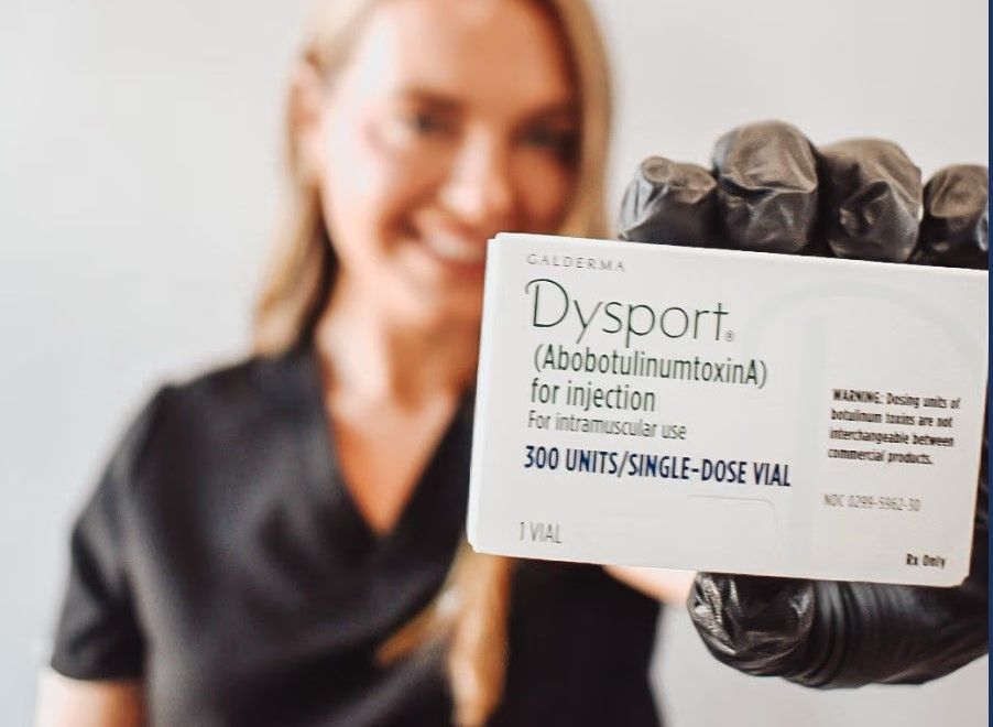 A woman is holding a box of dysport in her hand