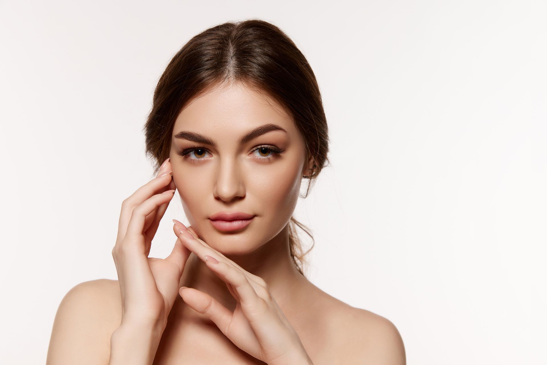 Woman showing her face after a dermal filler treatment.
