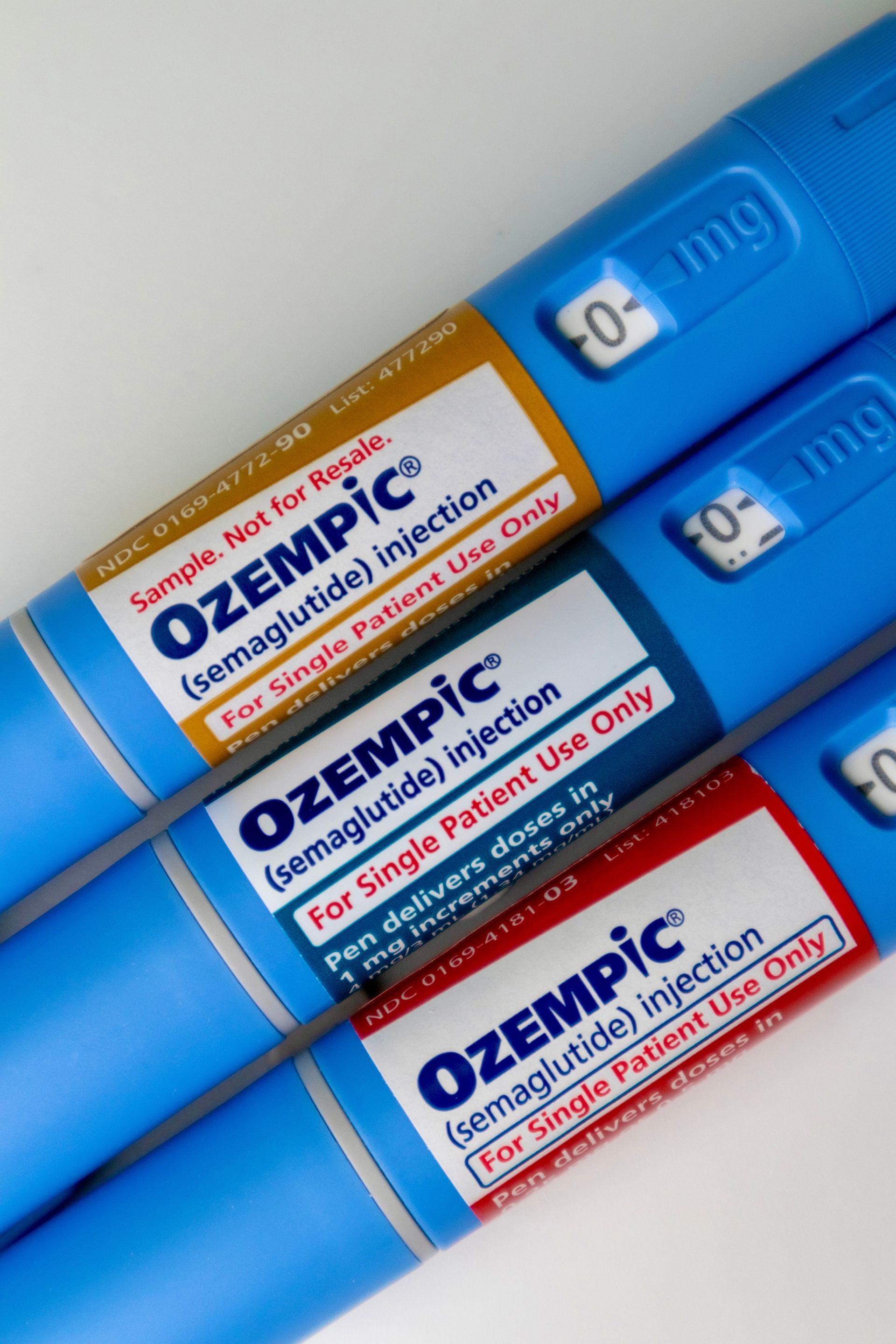 Three tubes of ozempic are stacked on top of each other