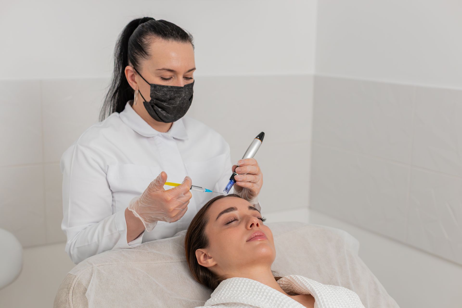 A woman is getting a microneedling with PRP treatment.