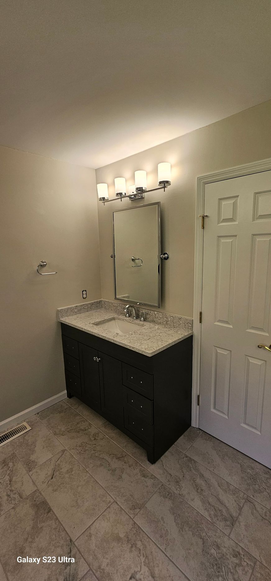 A bathroom with two sinks and a mirror.