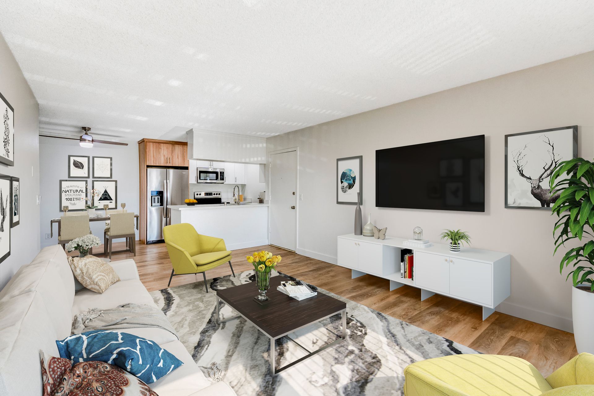 A living room with a couch , chair , coffee table and television.