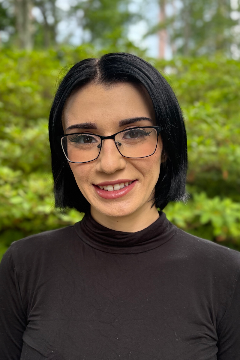 A close up of a woman 's face with a smile on her face