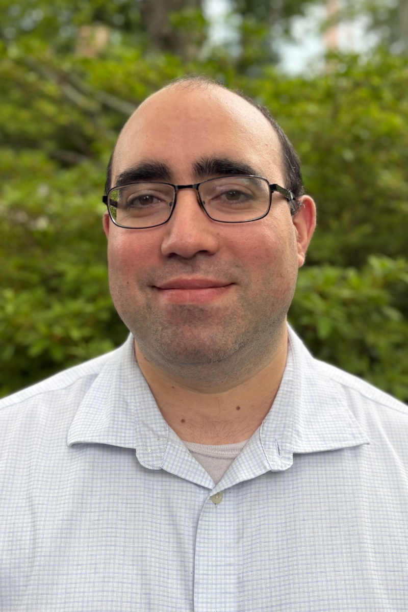 A silhouette of a man in a suit and tie without a face.