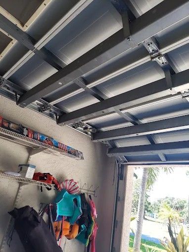 A garage with a ceiling that is very high and a door that is open.