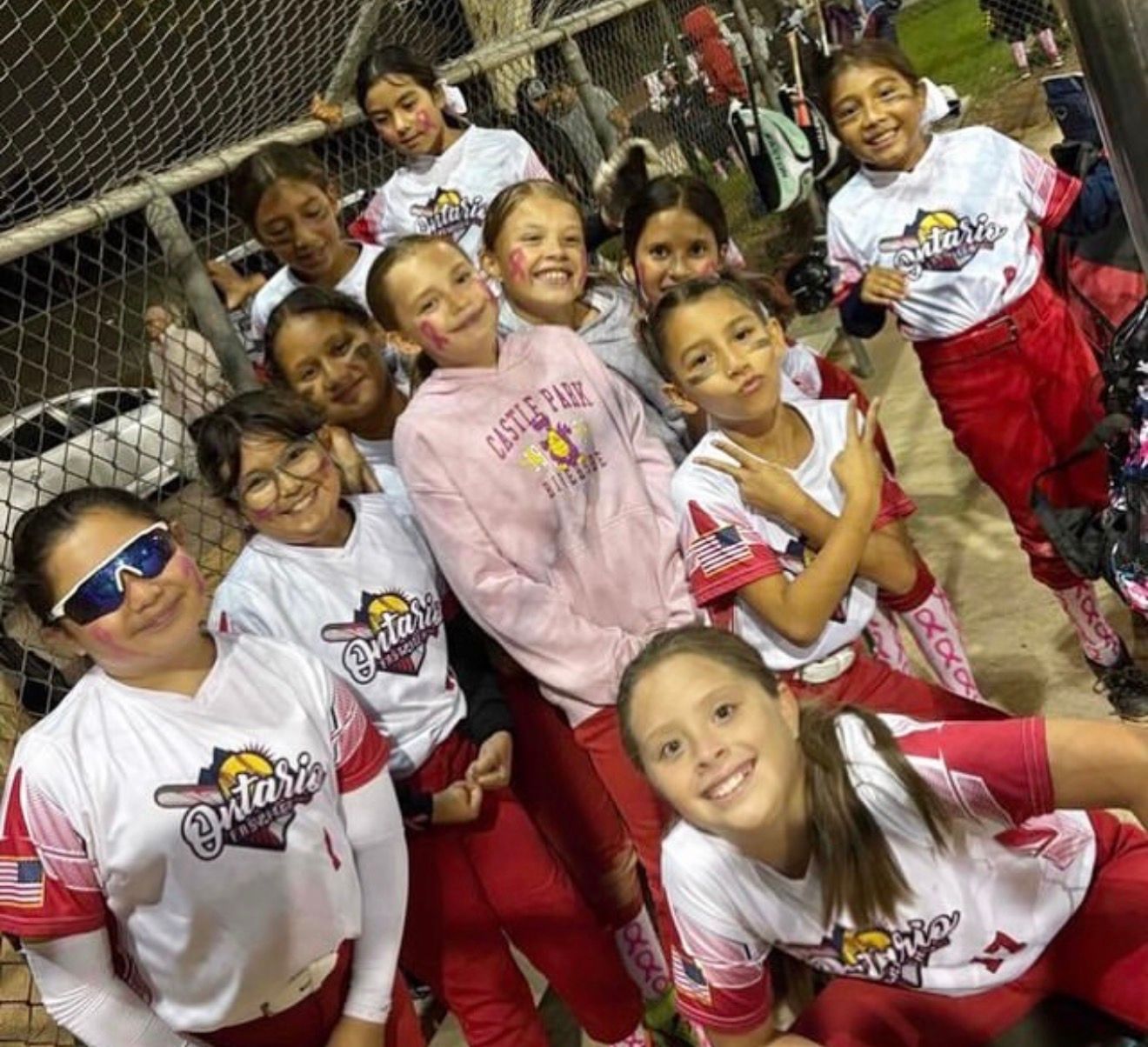 Baseball player sliding into base as another player attempts to catch the ball.