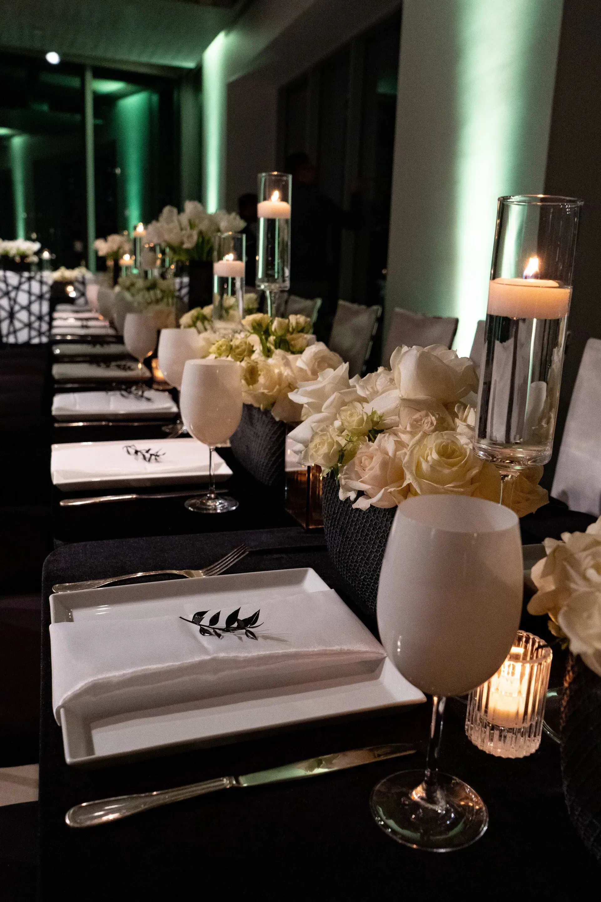 A long table with plates candles and flowers on it