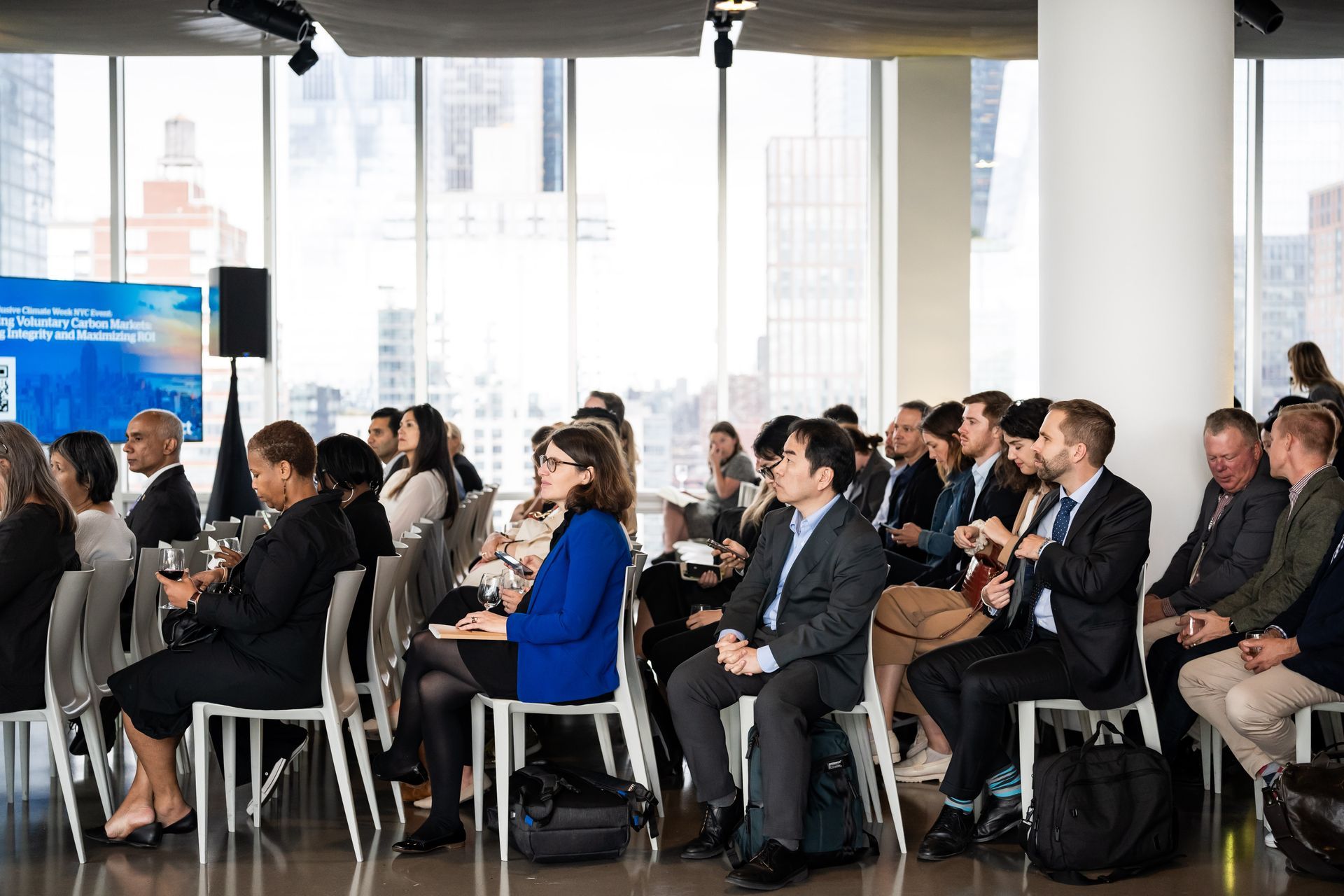 Snowy cityscape with buildings and a balcony.