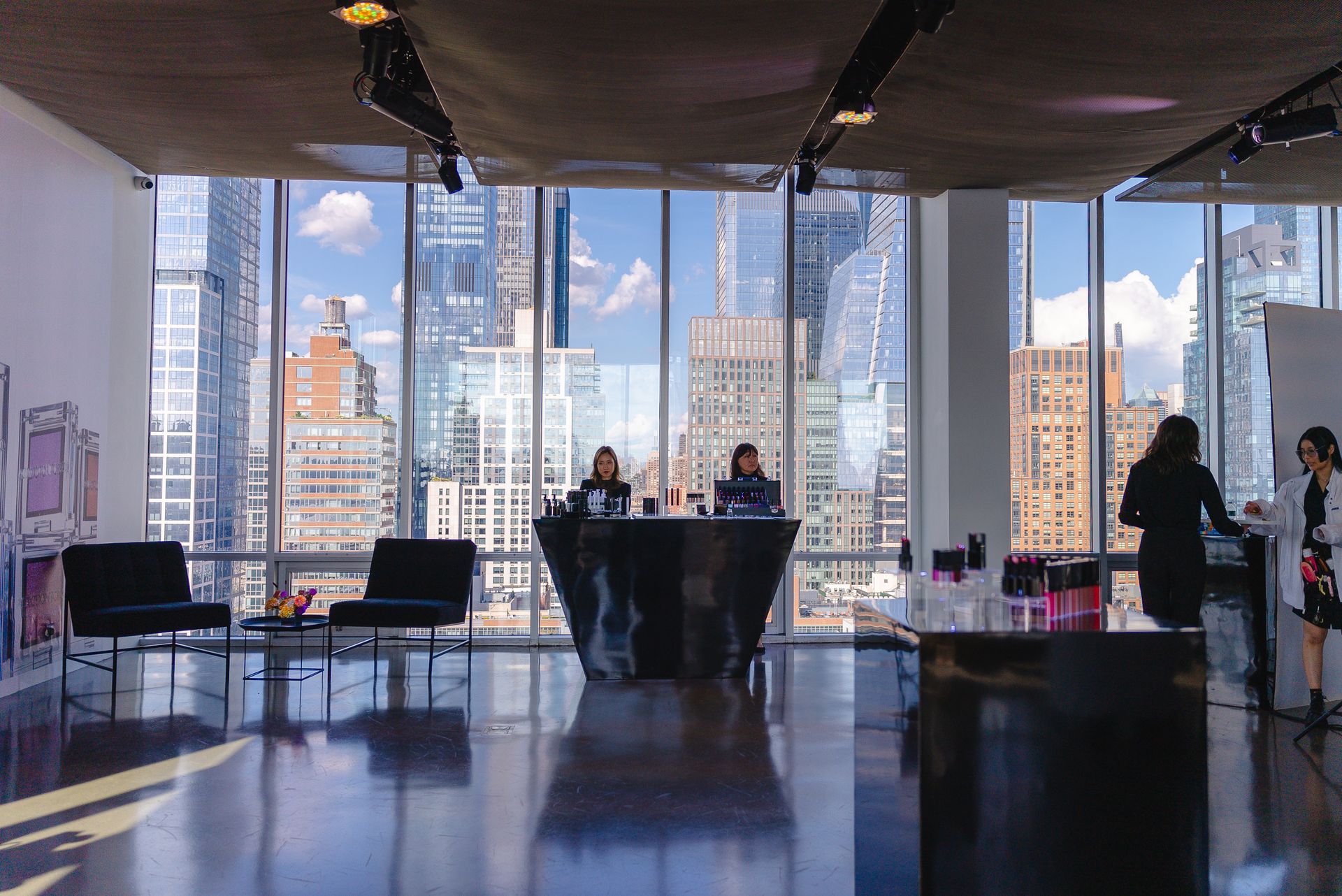 A woman is standing in front of a large window in a lobby.