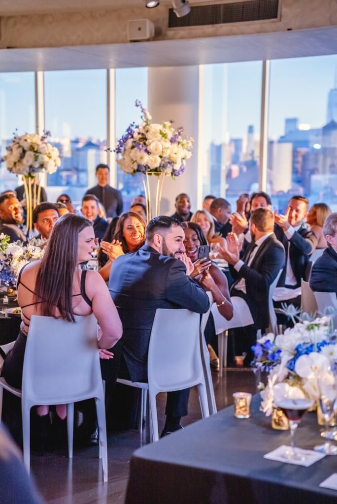 A group of people are sitting at tables at a wedding reception.