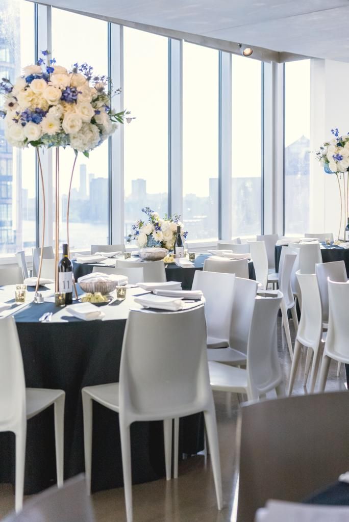 a dining room with tables and chairs set up for a wedding reception .