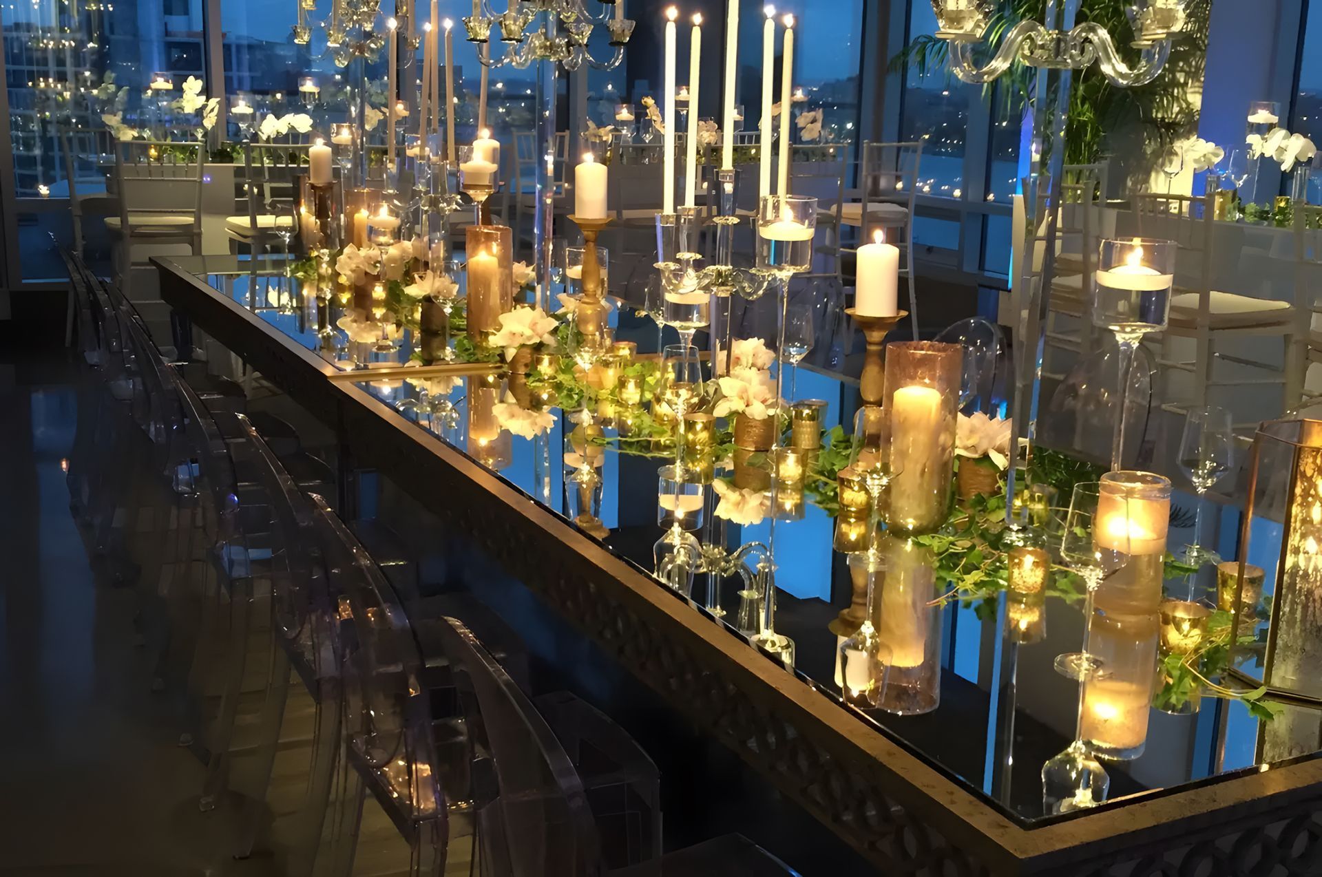 A long table with candles and flowers on it