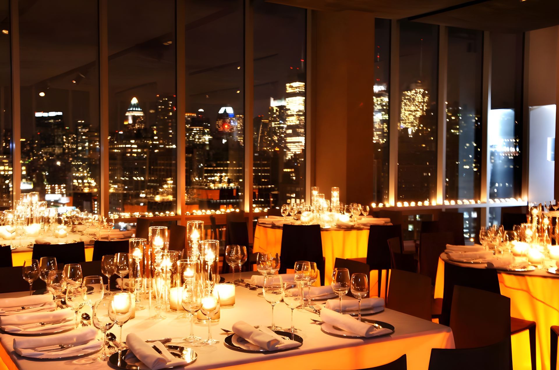 A restaurant with a view of the city at night