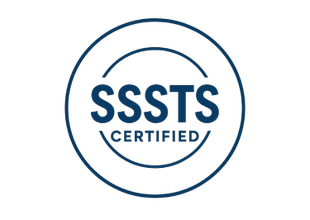 A dark blue, circular certification logo featuring the text 