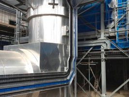 Industrial metal ducting and scaffolding structures on a construction site with silver insulated piping and blue tarps.