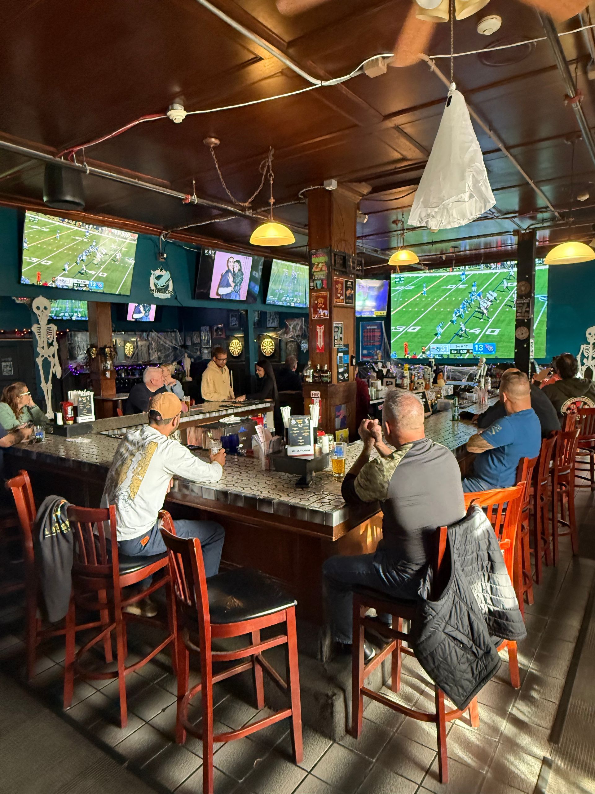 Group of people watching football at a sports bar.