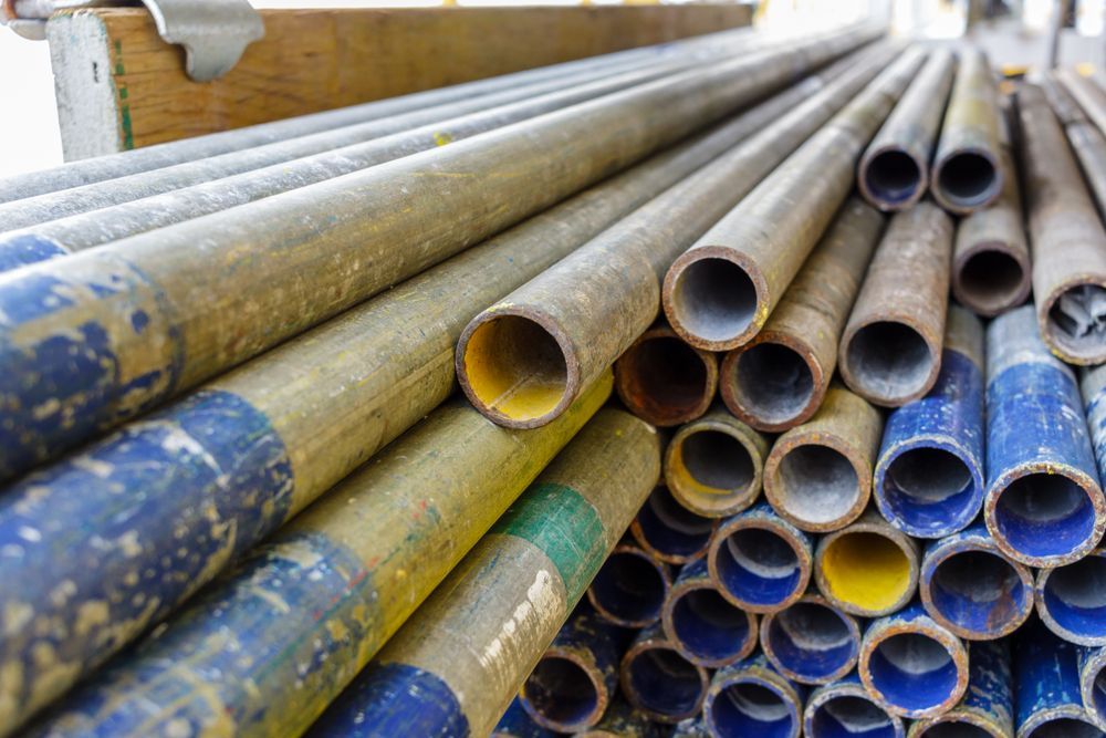 A Bunch of Metal Pipes Are Stacked on Top of Each Other — Byron Bay Scaffold in Kinvara, NSW
