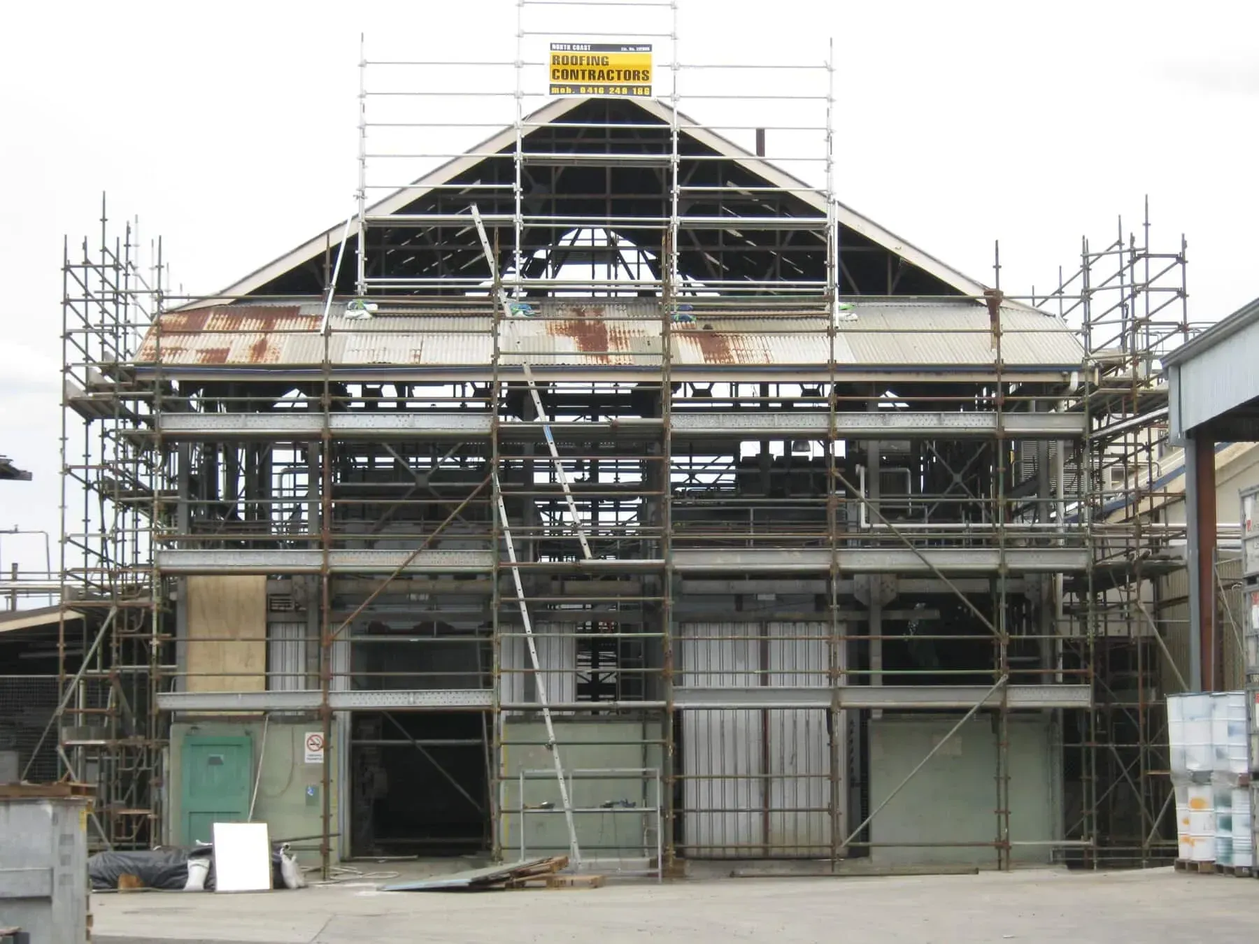 A Large Building Under Construction With Scaffolding Around It — Byron Bay Scaffold in Kinvara, NSW