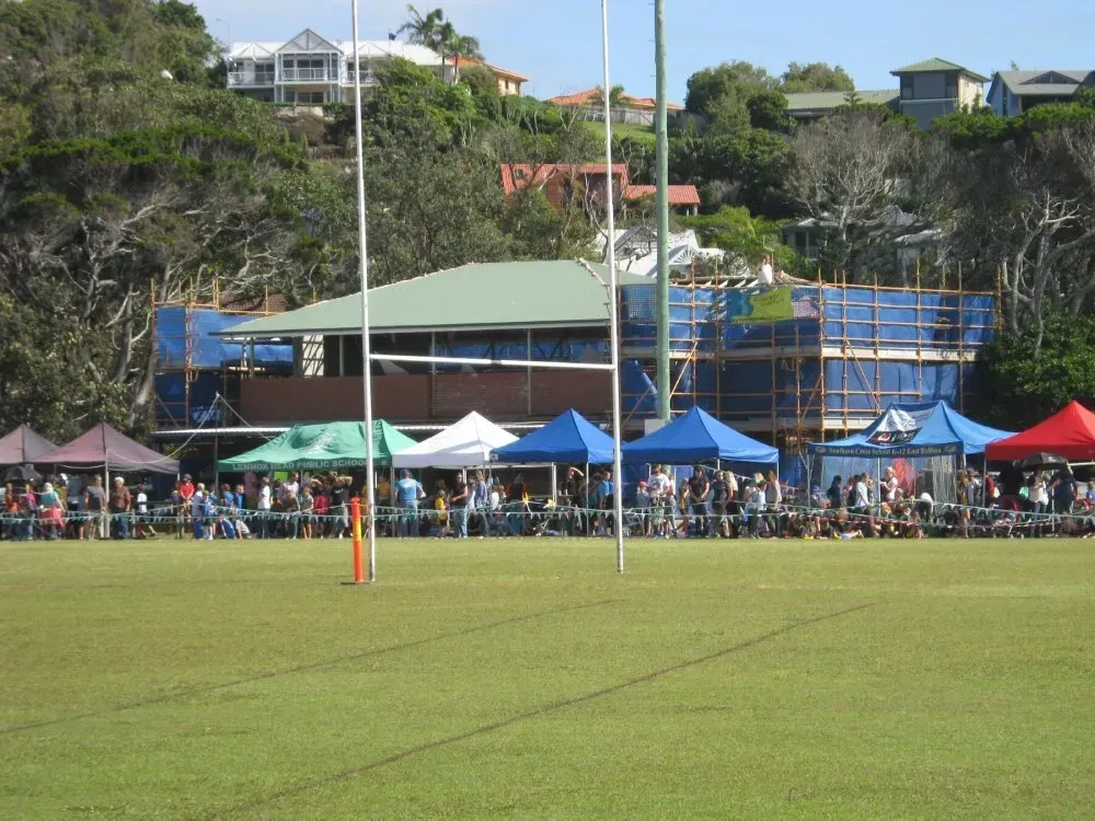 A Group of People Are Gathered in a Field With Tents — Byron Bay Scaffold in Kinvara, NSW