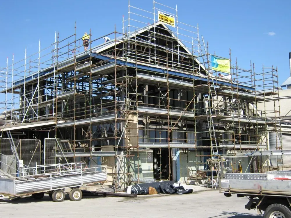 A Truck is Parked in Front of a Building Under Construction — Byron Bay Scaffold in Kinvara, NSW