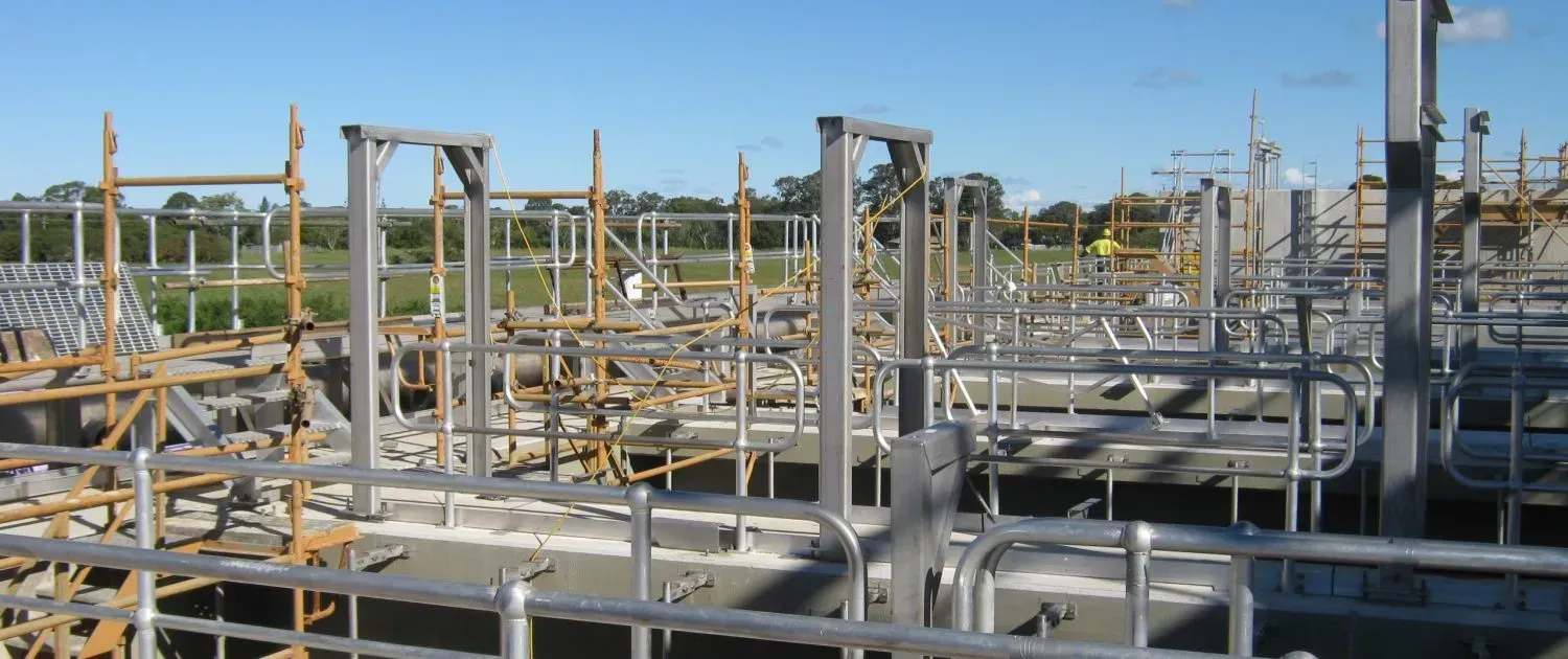 A Construction Site With a Lot of Pipes and Scaffolding — Byron Bay Scaffold in Kinvara, NSW