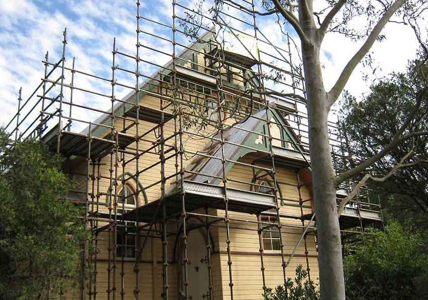A House With Scaffolding Around It and a Tree in Front of It — Byron Bay Scaffold in Kinvara, NSW