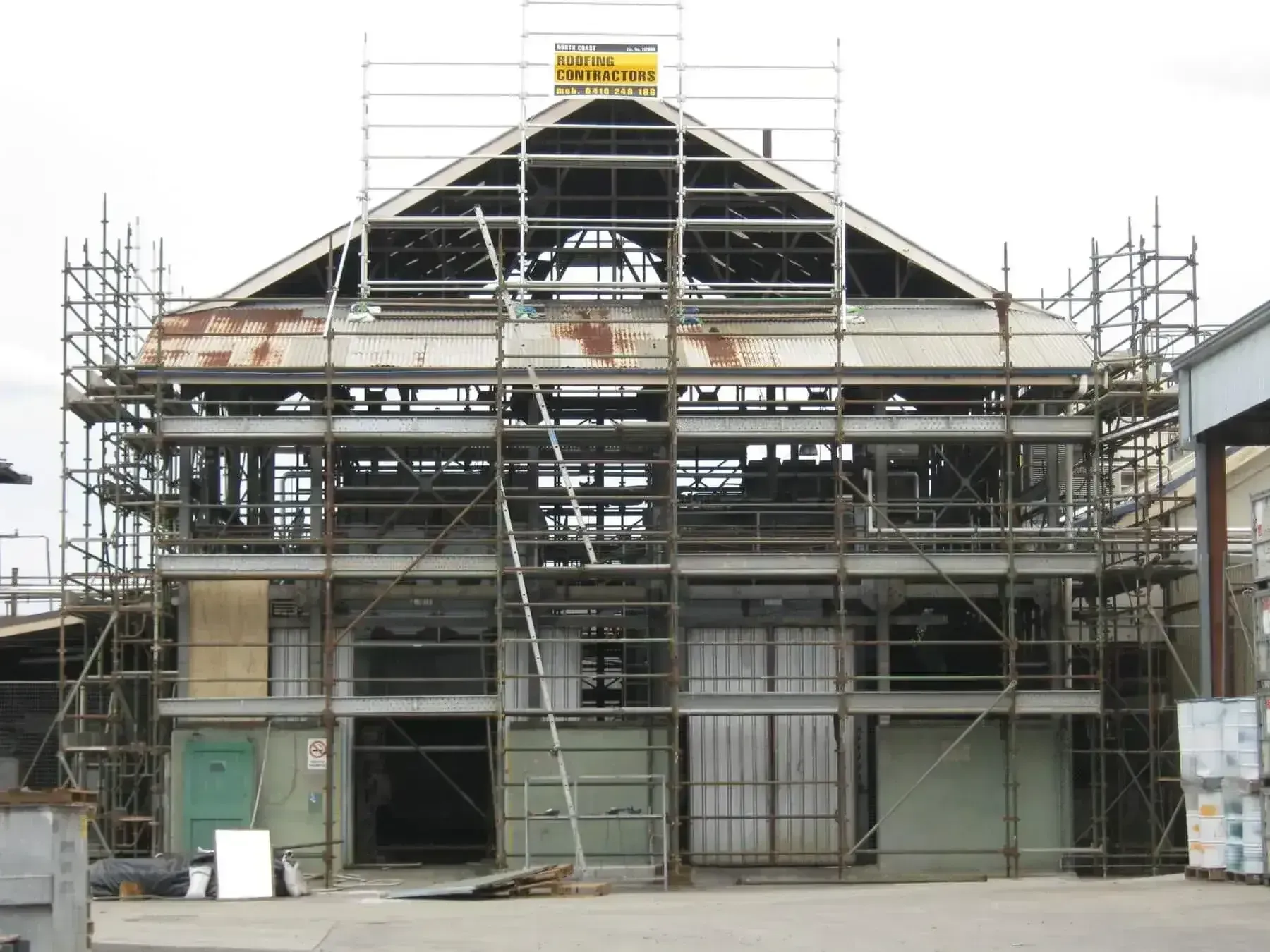 A Large Building Under Construction With Scaffolding Around It — Byron Bay Scaffold in Kinvara, NSW
