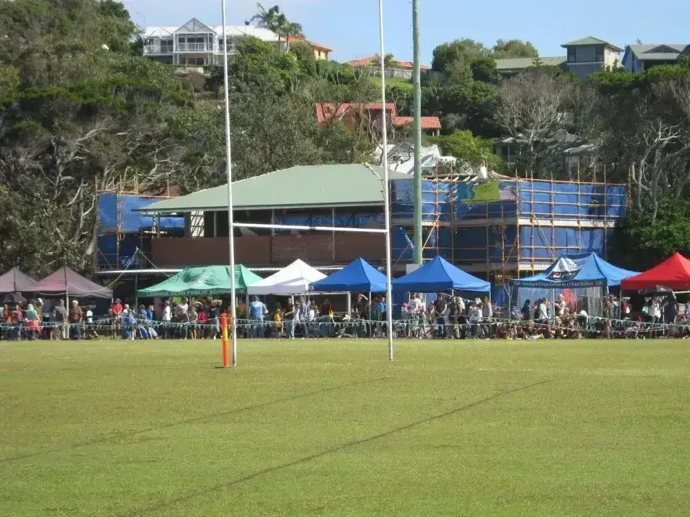 A Group of People Are Gathered in a Field With Tents — Byron Bay Scaffold in Kinvara, NSW