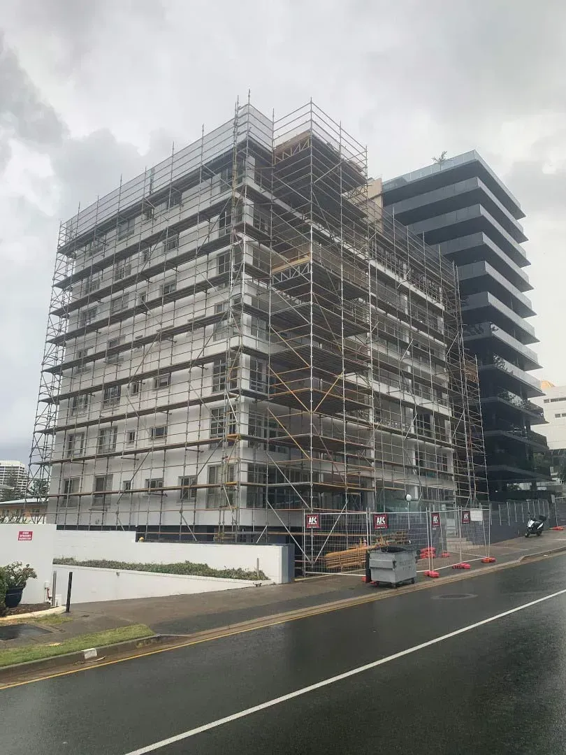 A Large Building is Being Built With Scaffolding Around It — Byron Bay Scaffold in Kinvara, NSW