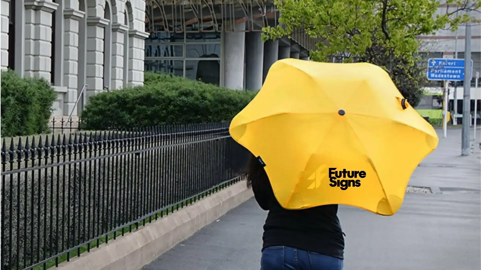 a person holding a yellow umbrella that says complete digital