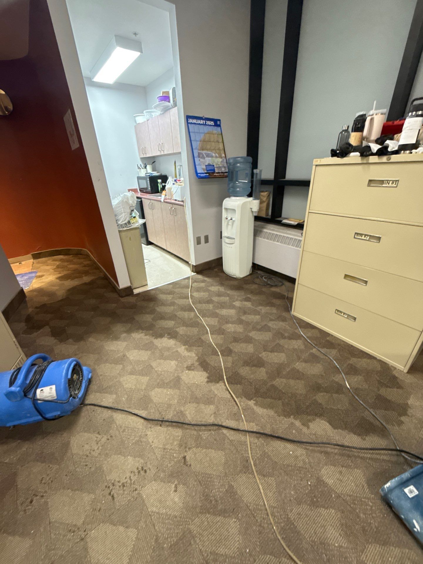 A vacuum cleaner is sitting on the floor of a room.