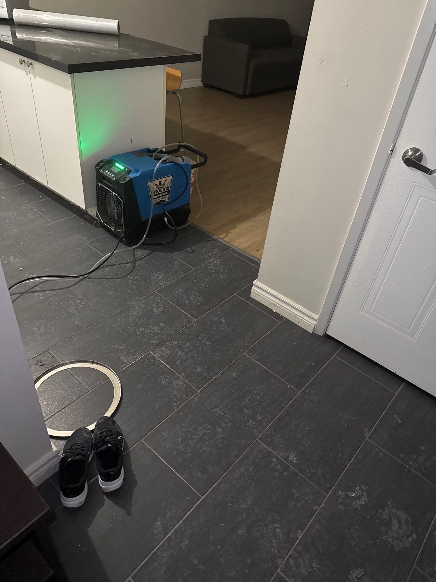 A pair of shoes are sitting on the floor next to a machine.