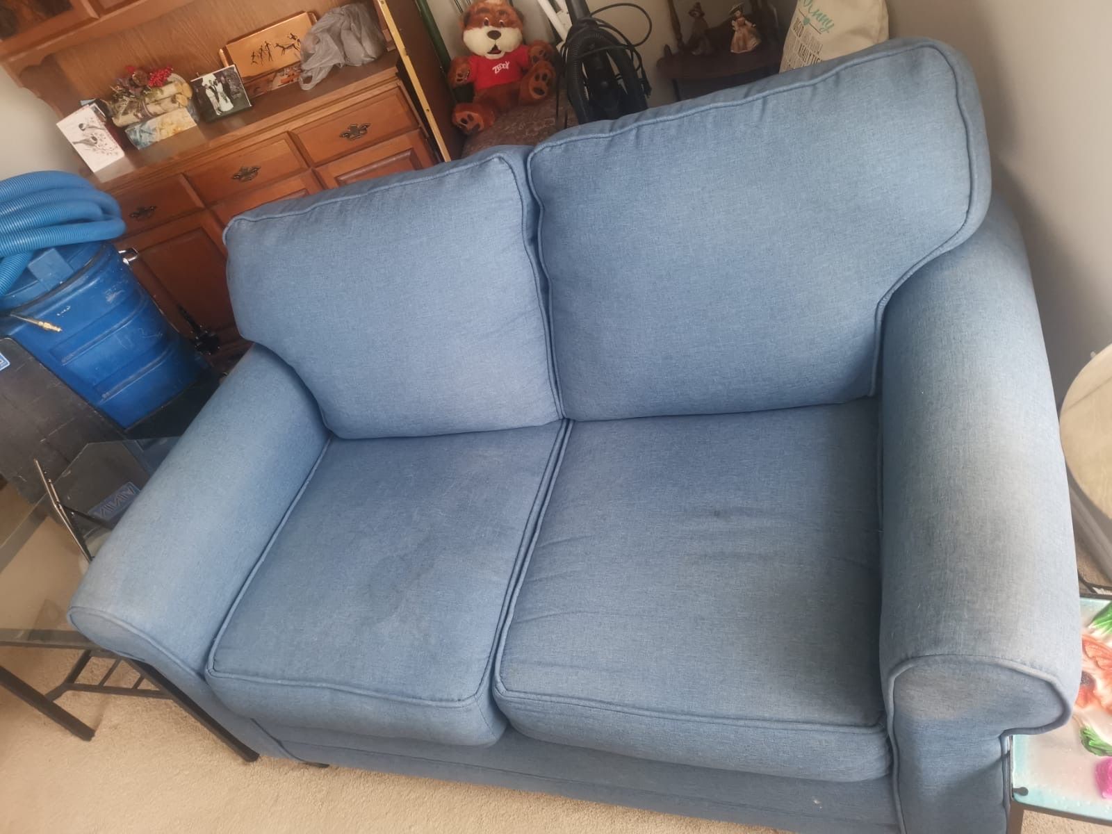 A blue couch is sitting in a living room