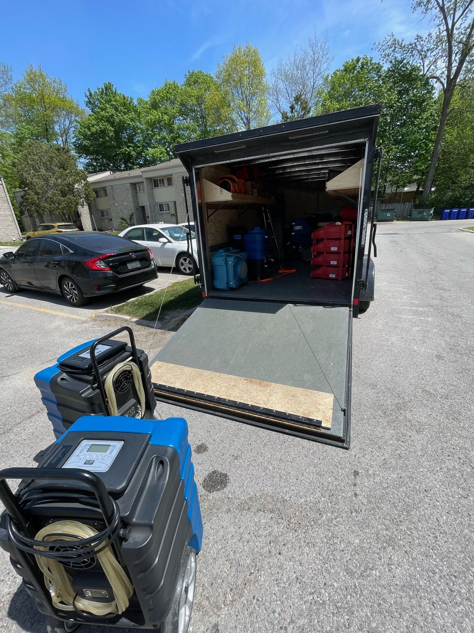 A truck is sitting in a parking lot next to a couple of generators.