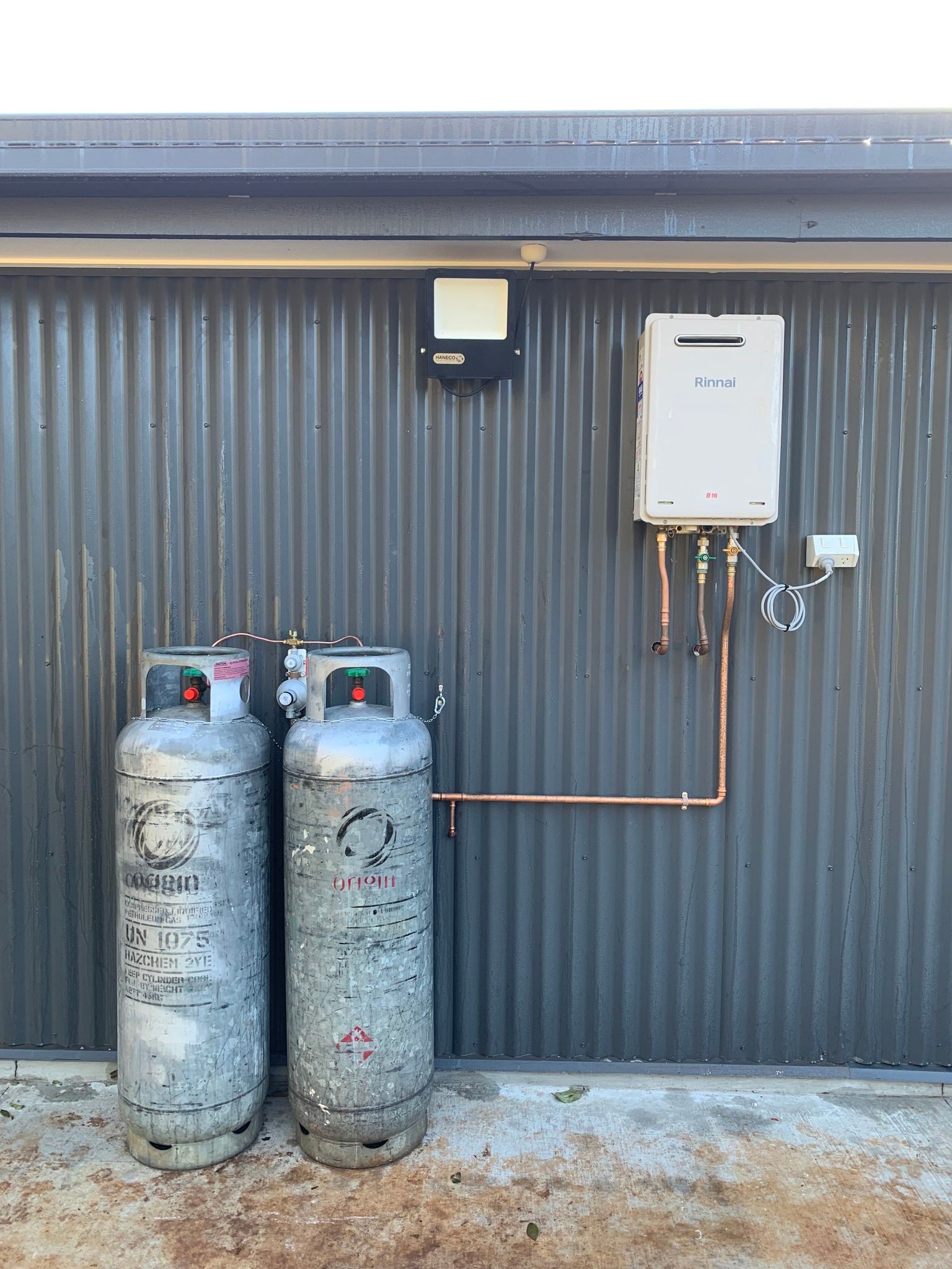 A Three-Stage Water Filtration System Mounted in a Black Metal Frame — Mates Plumbing and Gas in Lammermoor, QLD