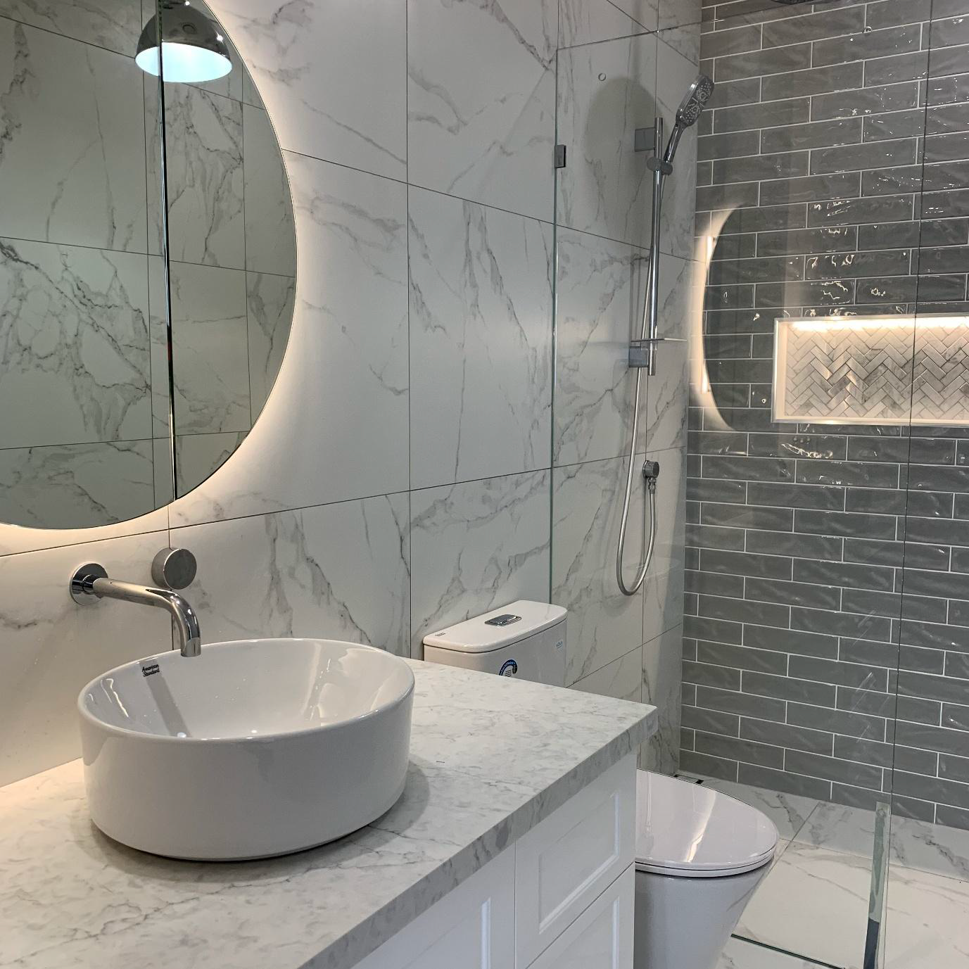 A White Downpipe Gutter Outlet Connecting to a Vertical Pipe — Mates Plumbing and Gas in Lammermoor, QLD