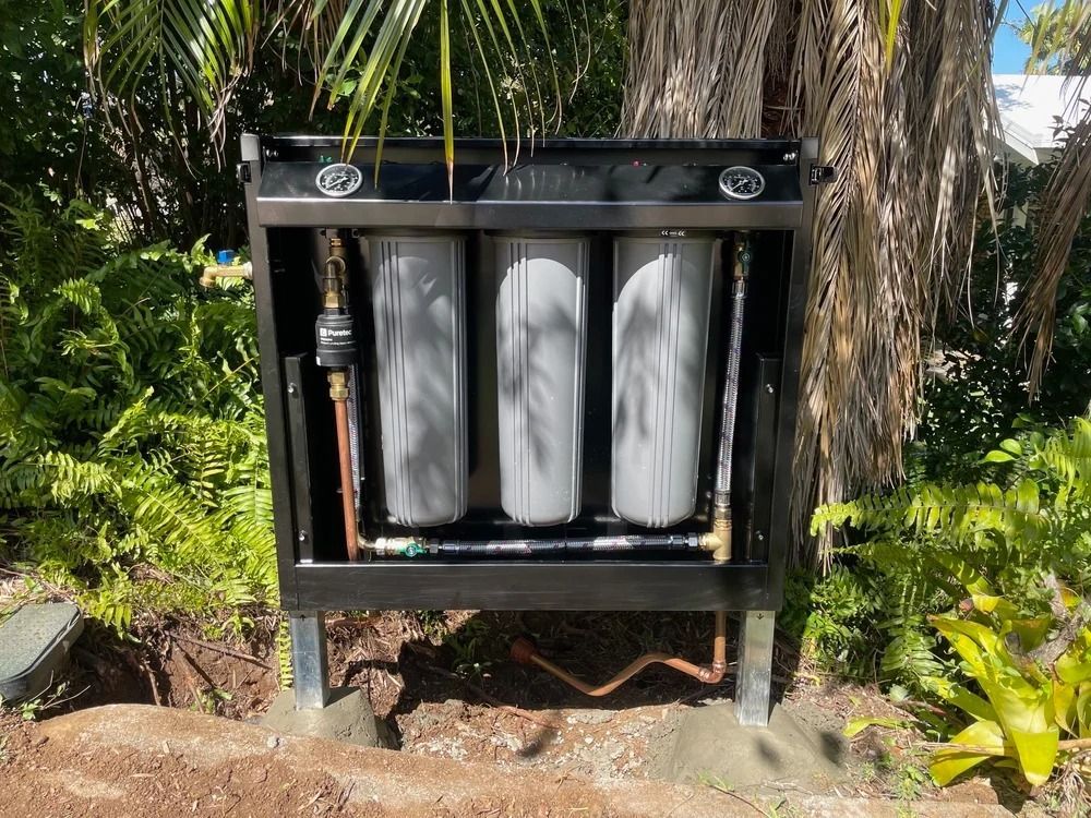 A Beige Brick House Exterior With A White Gutter System And Downpipe — Mates Plumbing and Gas in Lammermoor, QLD