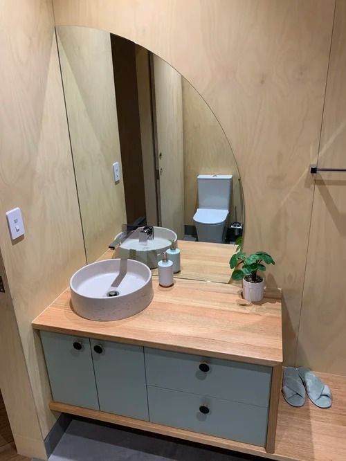A Modern Bathroom Vanity With a Light Wood Countertop — Mates Plumbing and Gas in Lammermoor, QLD