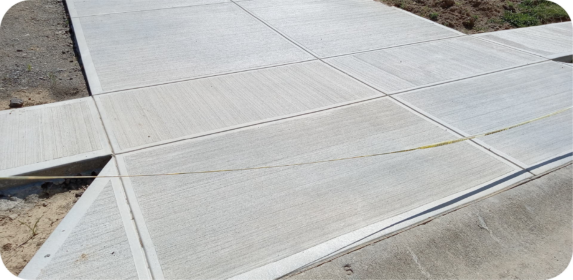 A concrete sidewalk is being built next to a road.