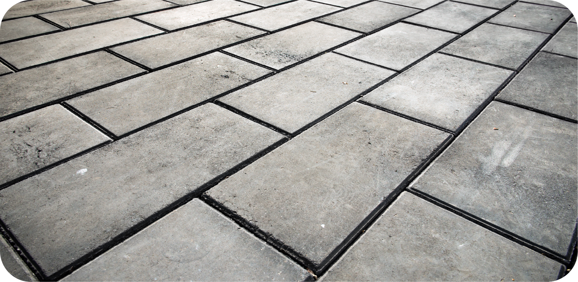 A black and white photo of a brick floor.